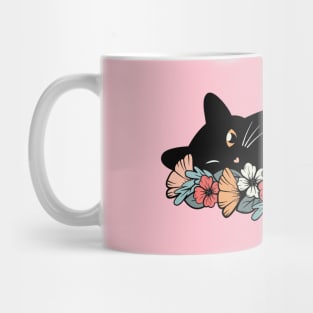 Cute black cat on a bed of flowers Mug